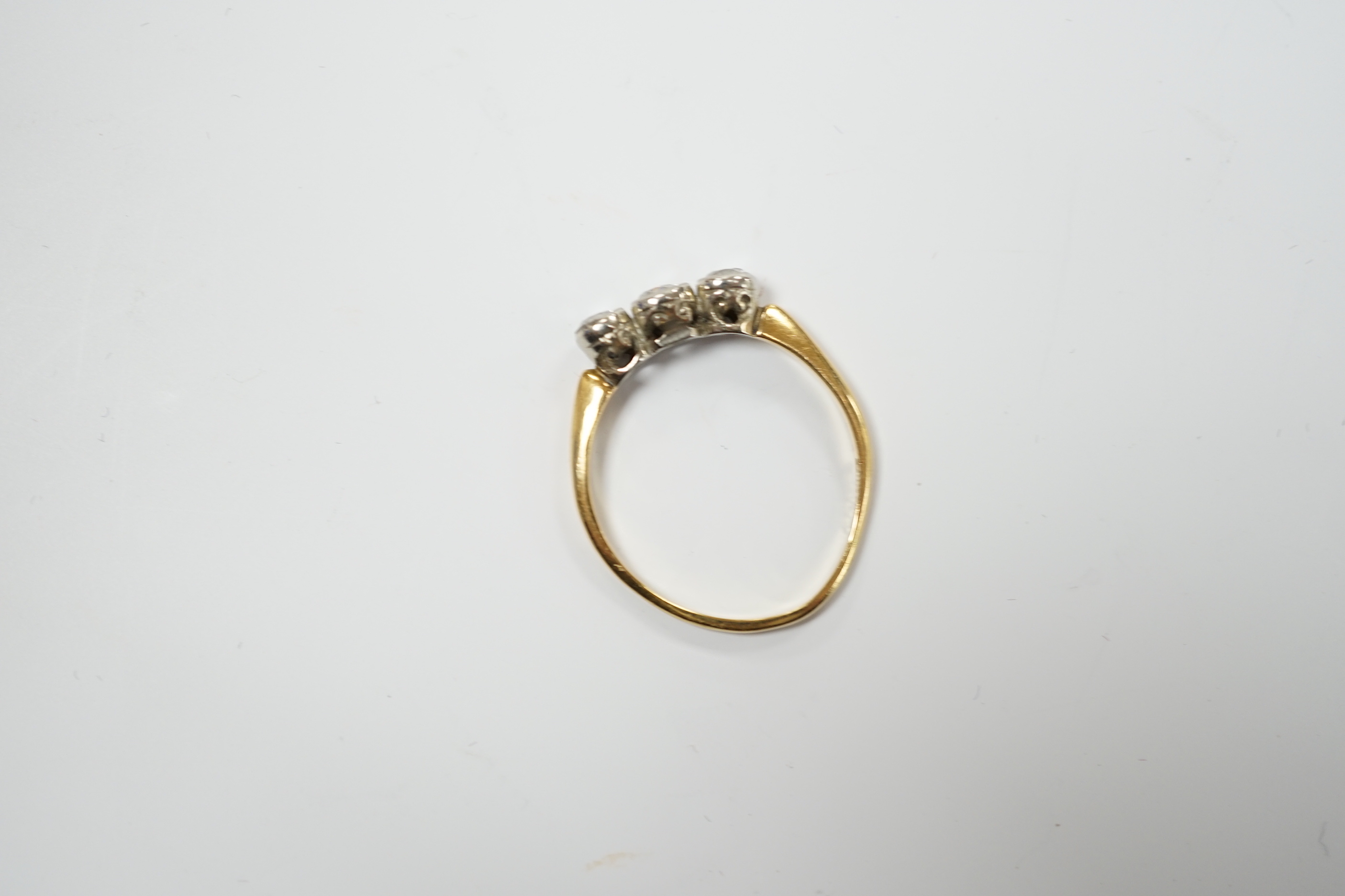An 18ct and collet set three stone diamond ring, size R, gross weight 2.6 grams.